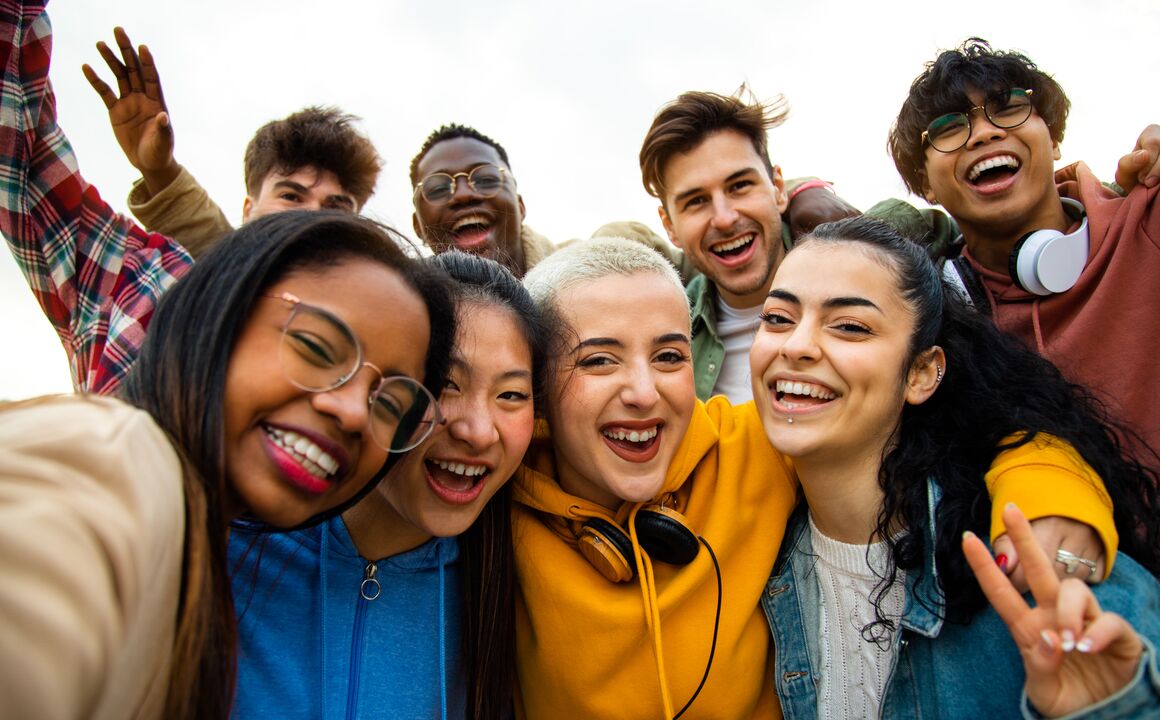 A group of people smiling while looking at the camera.