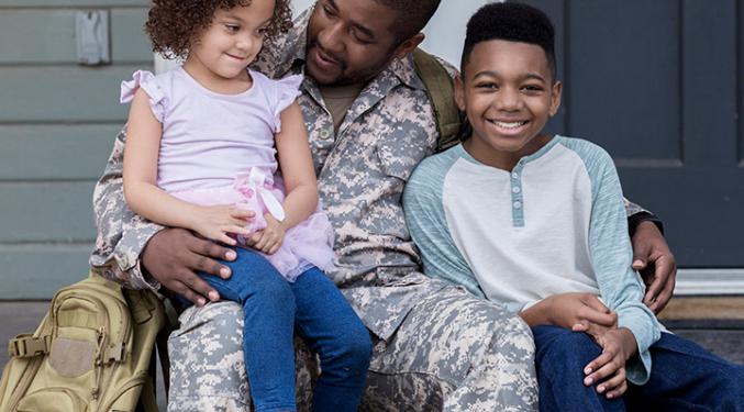 Military father holding his two children