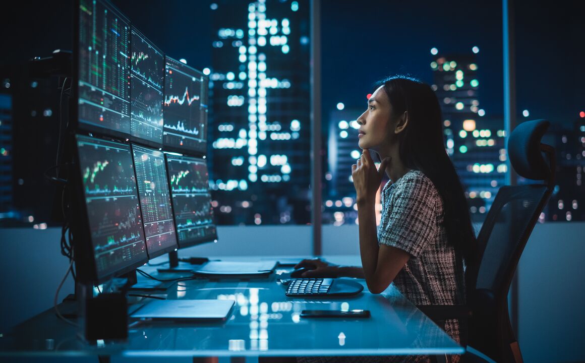 A woman analyzing data on her computer.