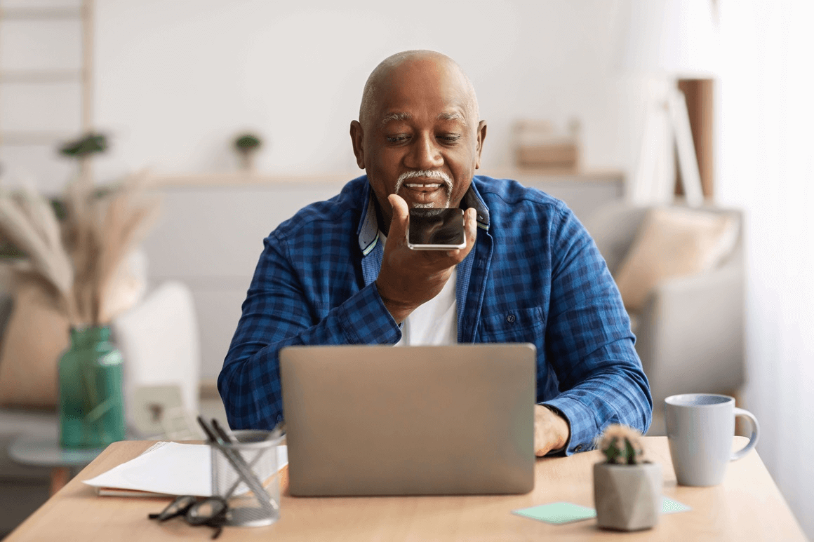 African American man holding cellphone up to his mouth