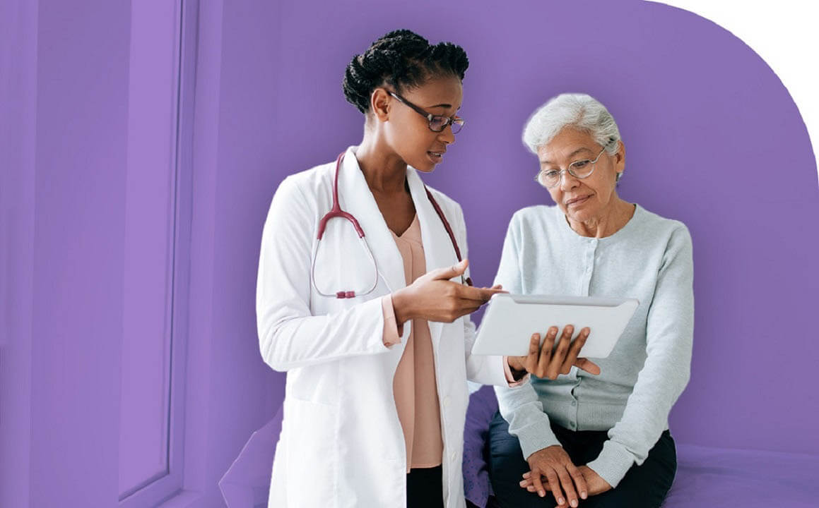 physician reviewing tablet with patient