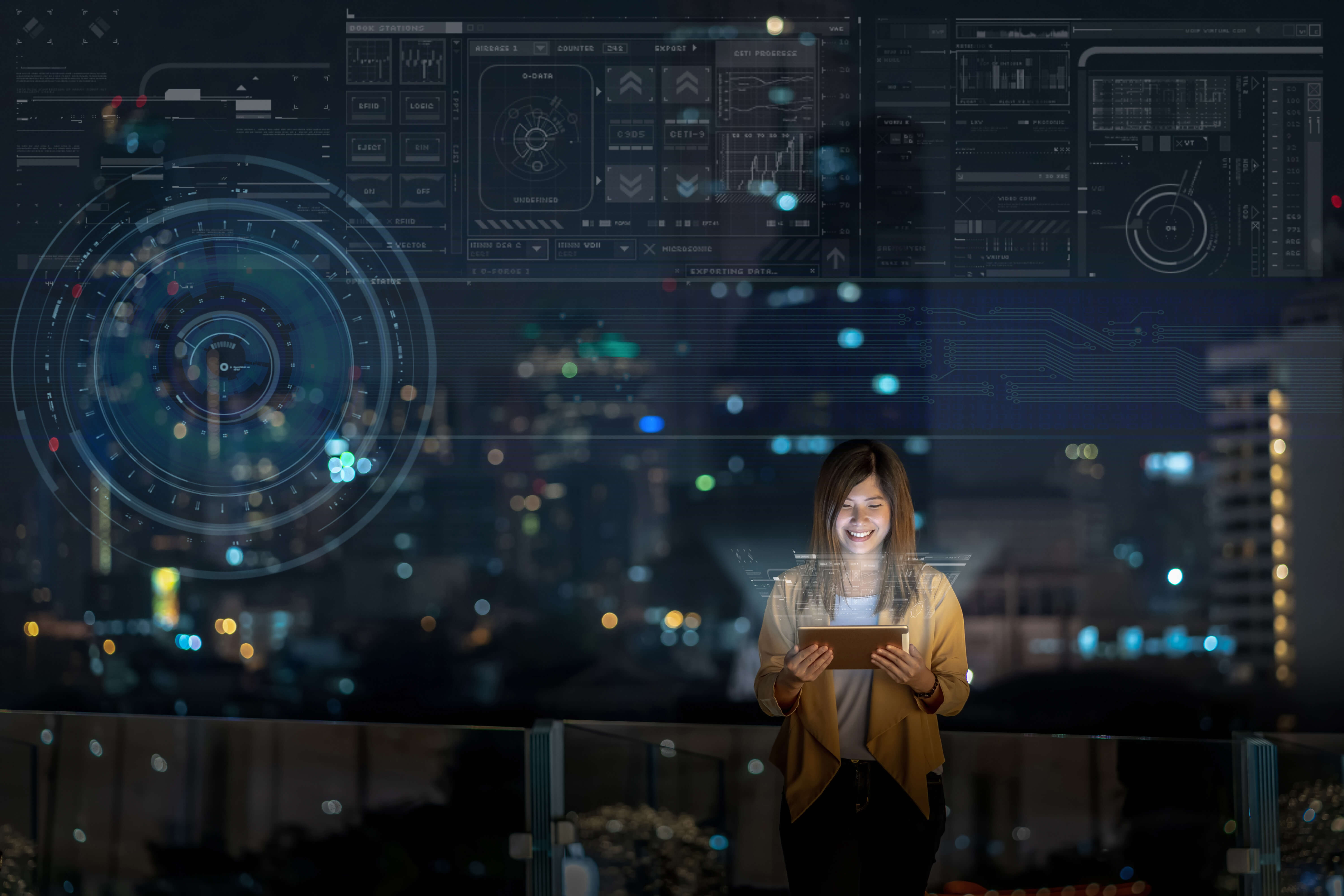 Businesswoman using tablet with smile, showing digital virtual screen over the cityscape background at night time