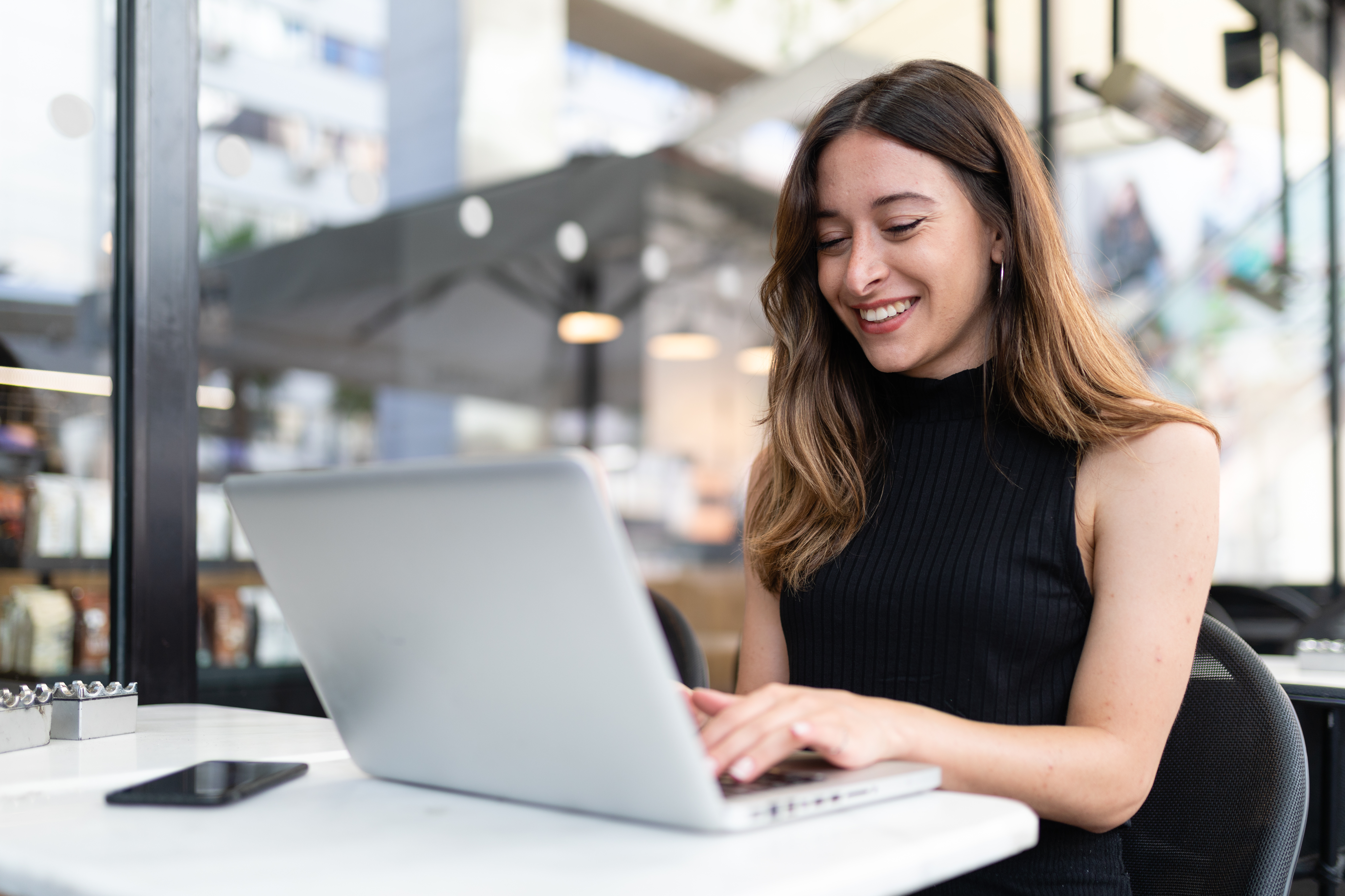 Business woman work process concept. Young woman working university project with generic design laptop. Blurred background, film effect..