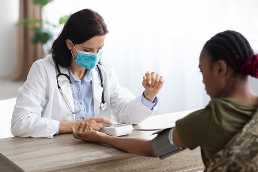 Female soldier getting a medical exam.