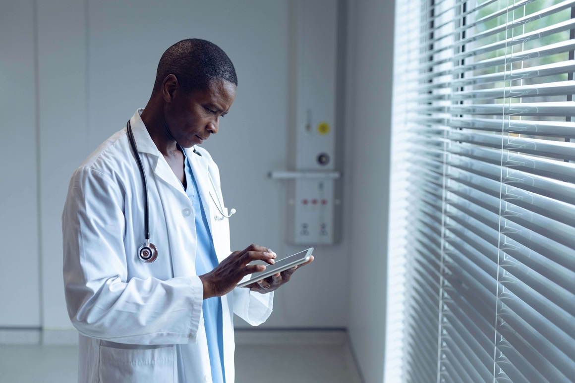 Triage nurse looking at patient information on a tablet