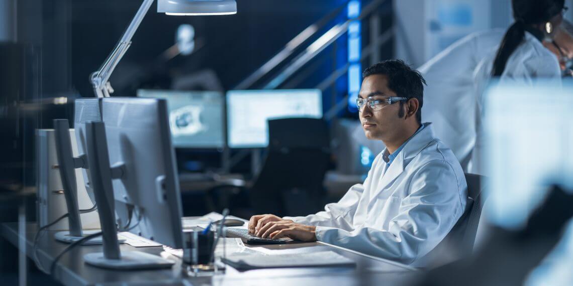 A lab worker on his computer.