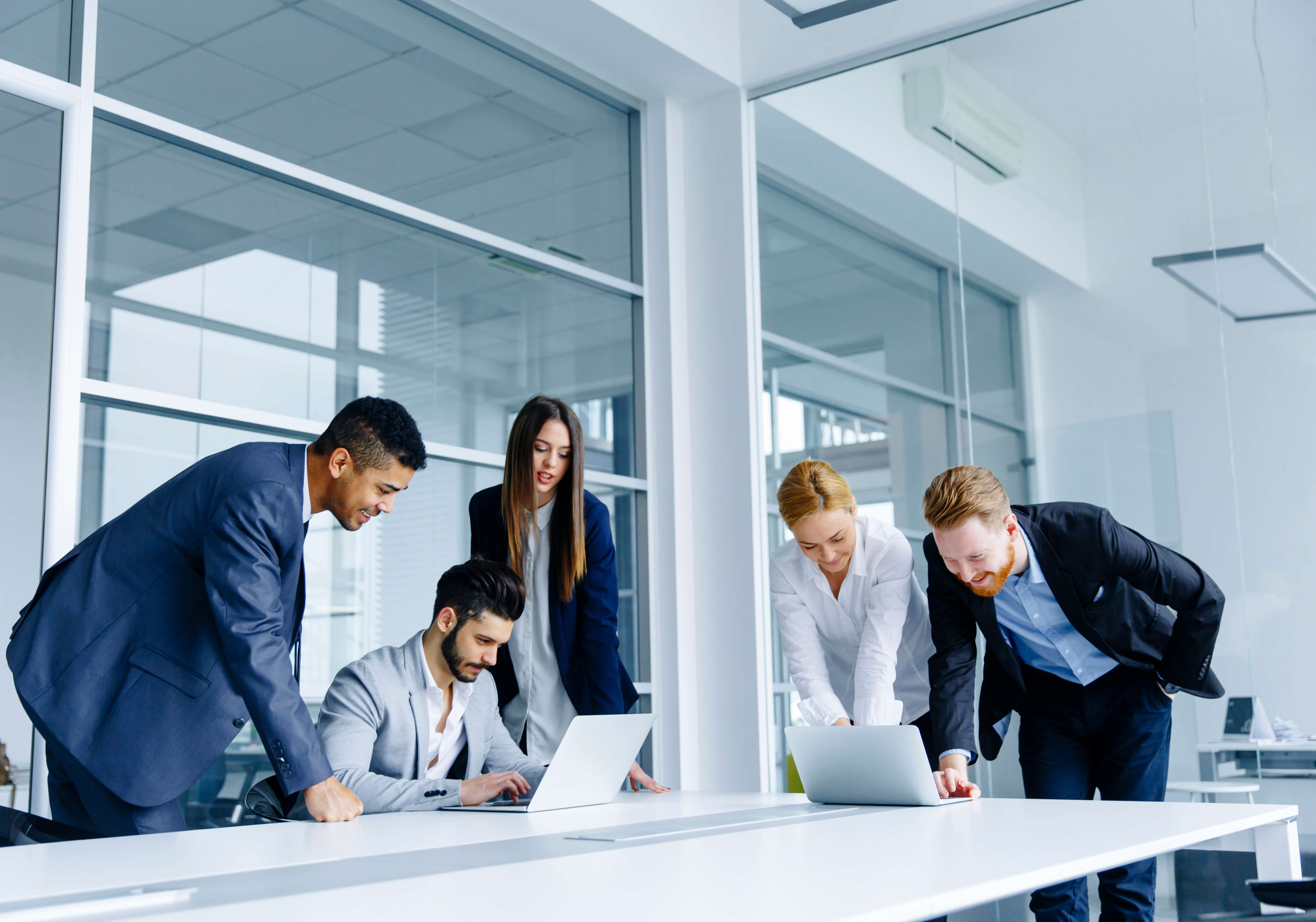 Colleagues in a modern office collaborating over an outcome-based contract