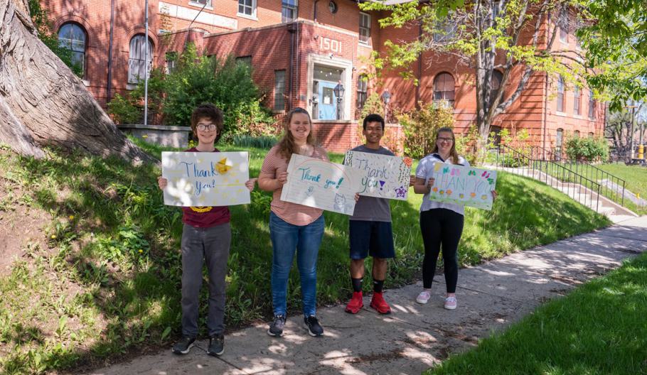 A group of youth who have received services from Denver Children's Home (DCH) holds signs to show their appreciation. 