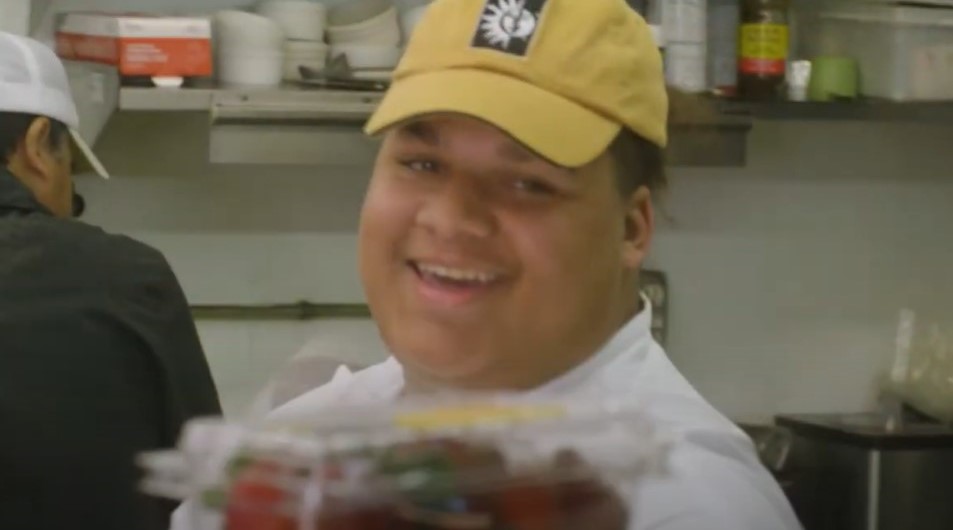 Hibiscus former resident smiling while in the kitchen