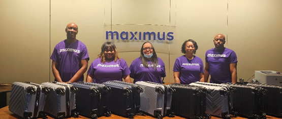 Members of the Maximus Child Support team donating suitcases for asylum seekers on donation day 