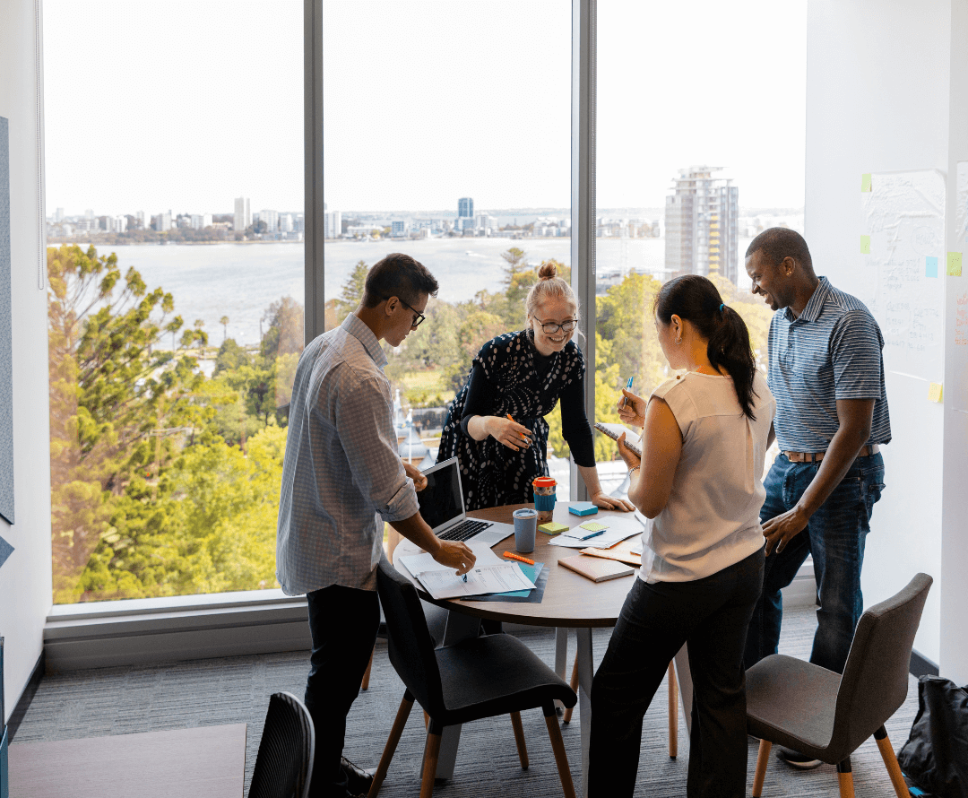 Business colleagues standing around a table having a discussion.