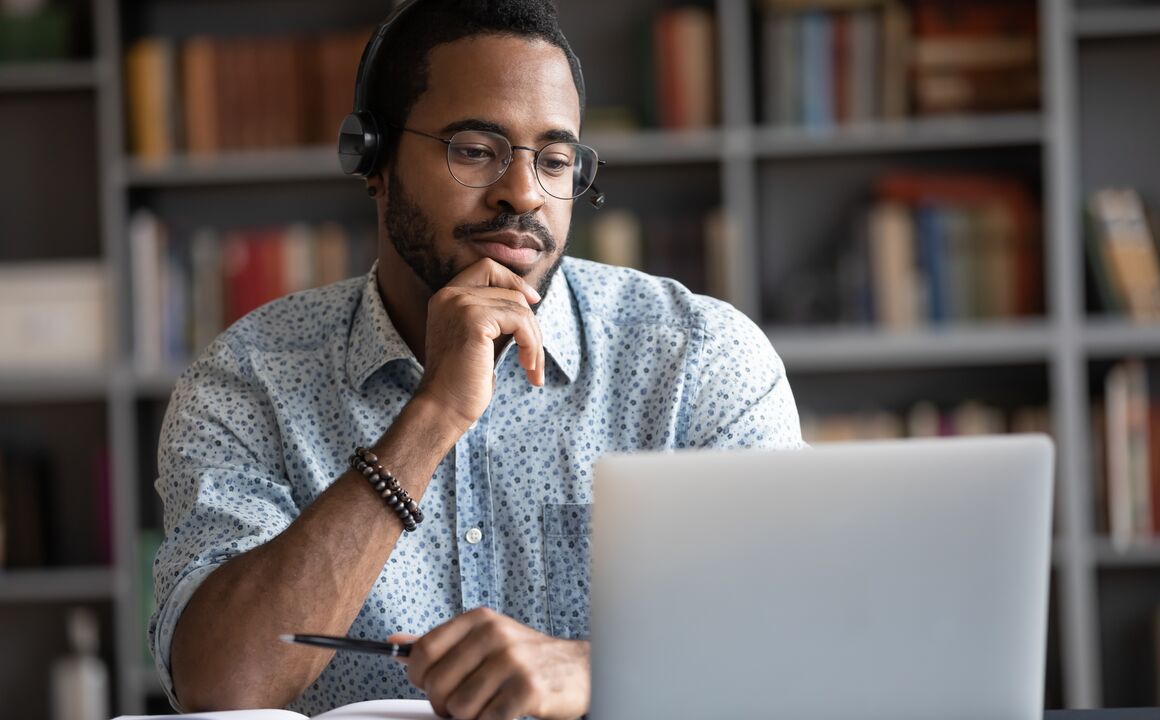 Man watching a webinar on his laptop