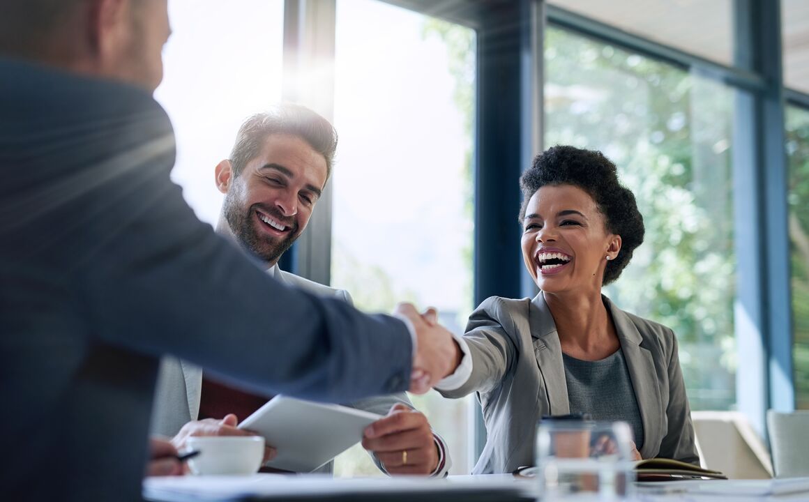 woman shaking hands with colleague 