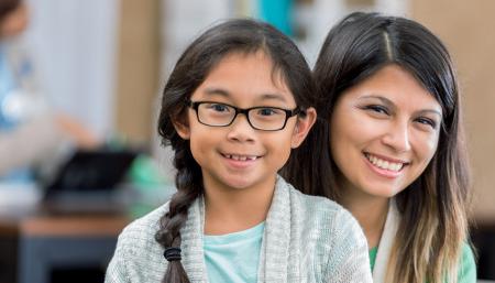 Mother and daughter smiling