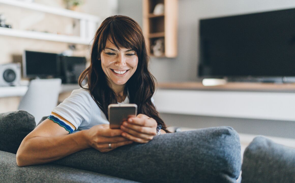 Woman uses smartphone to enroll in a government program