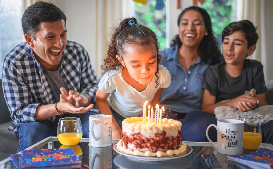 A healthy and happy family covered by health insurance celebrates a child's birthday