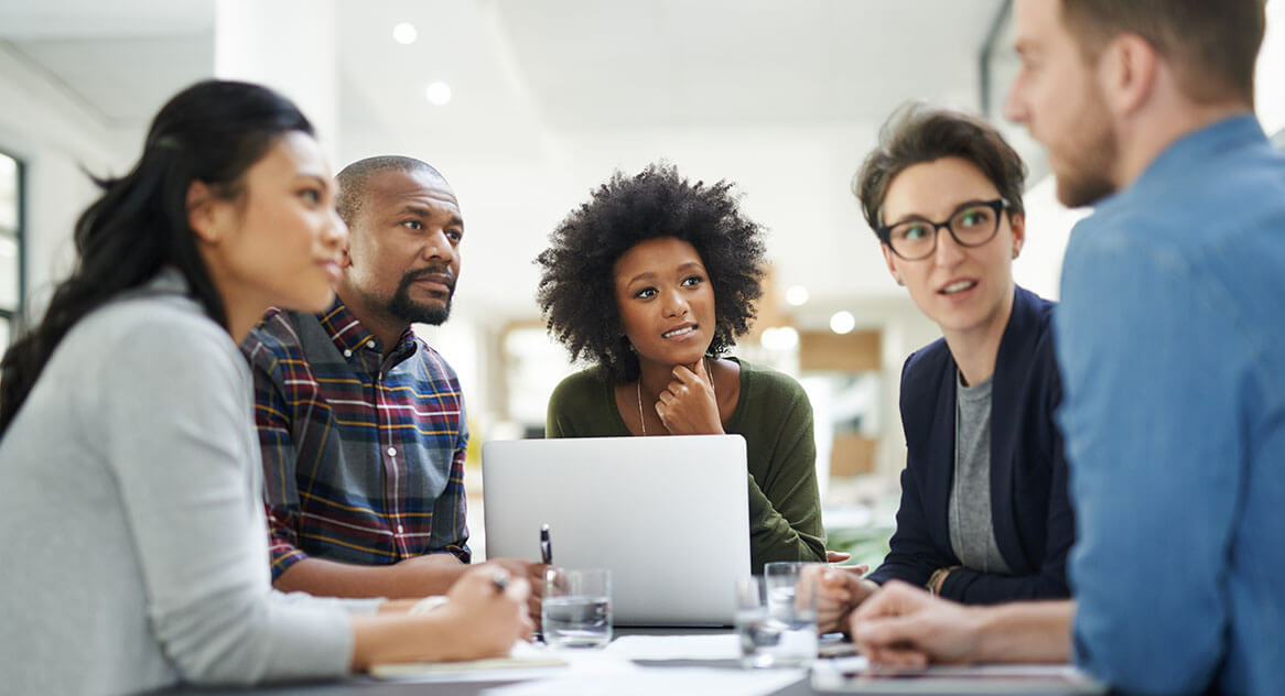 A group of business process reengineering experts listen to a government agency leader.