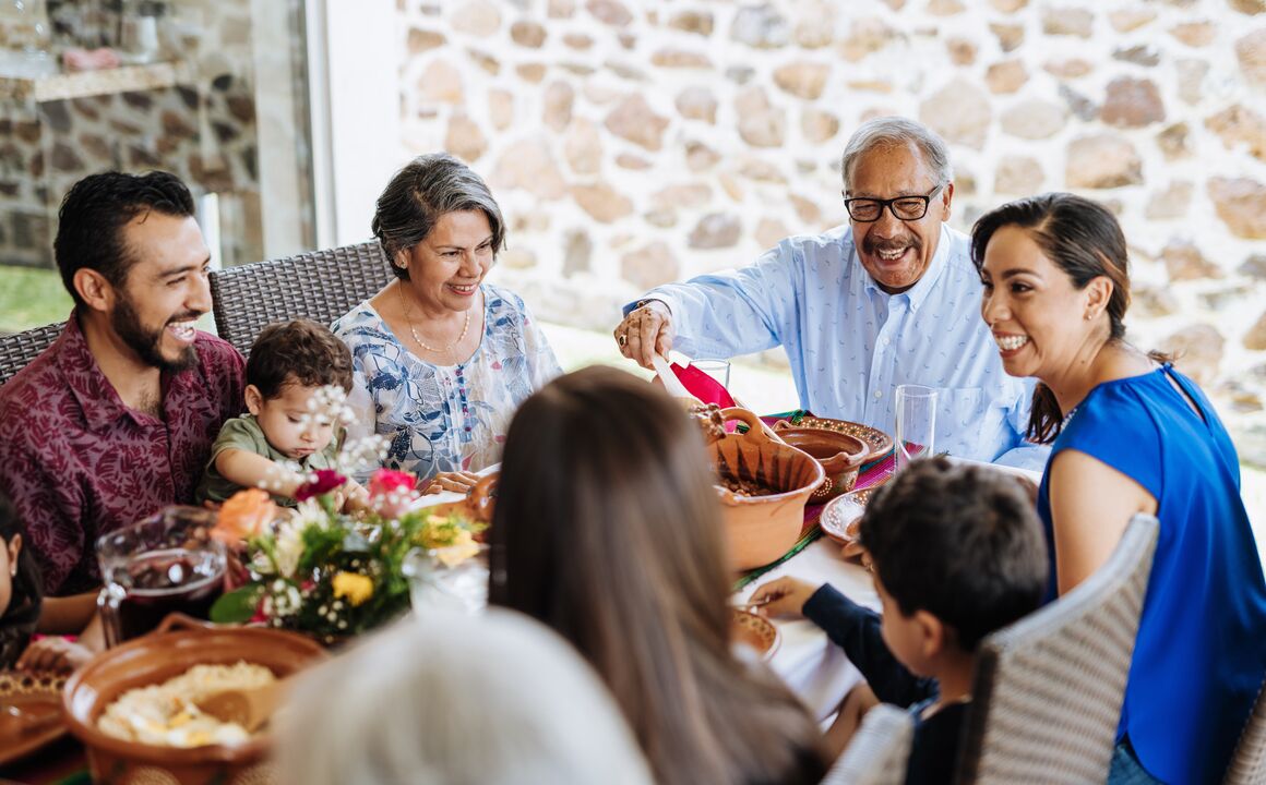 multi-generation family enjoys dinner on terra cotta pottery plates