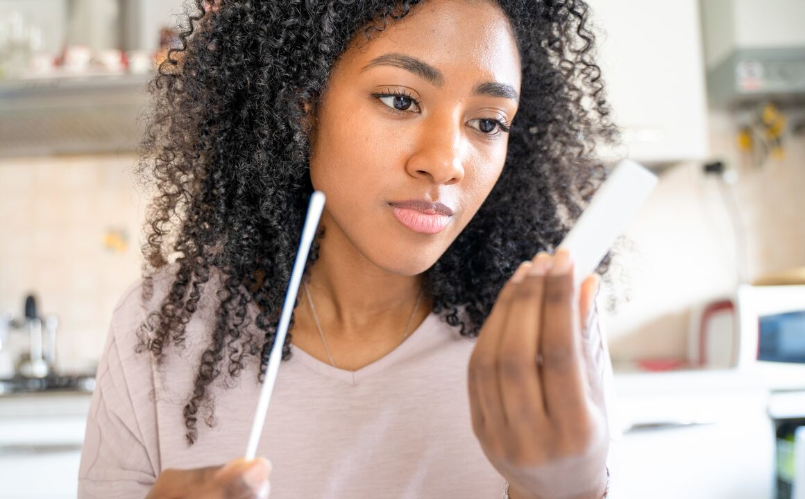 Young woman awaits the result of a COVID-19 home-test before she provides the information to the Maximus contact tracer. 