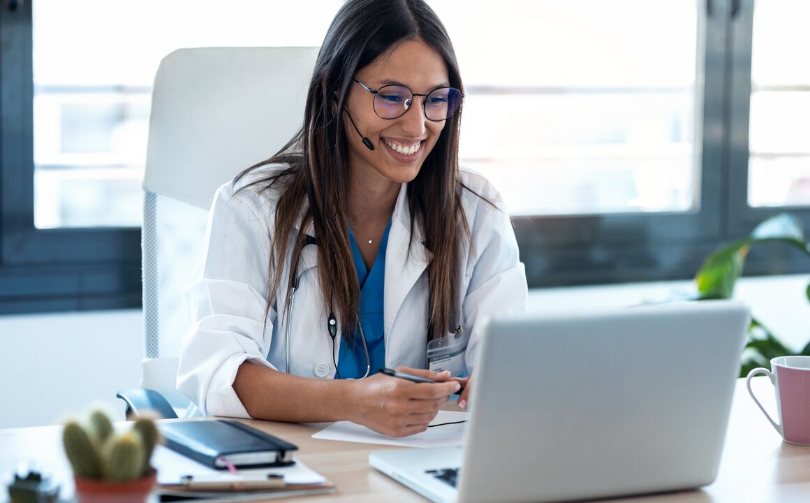 woman sitting at desk with a laptop