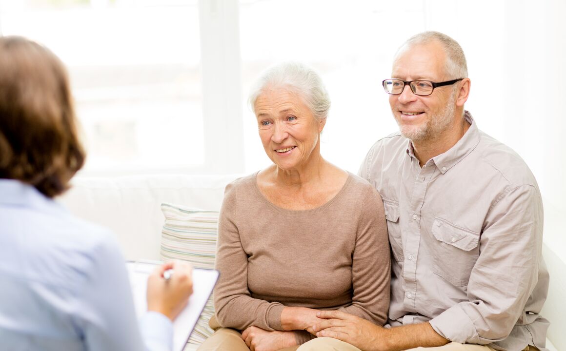 Older couple being consulted with a woman with a clipboard.