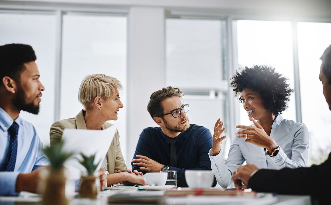 A group of diverse office workers in a meeting.