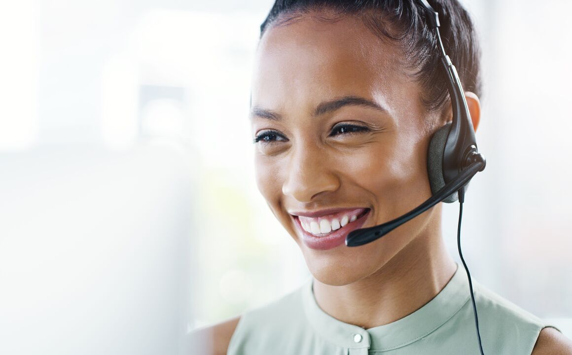 Smiling female contact center agent answers questions about SNAP benefits.
