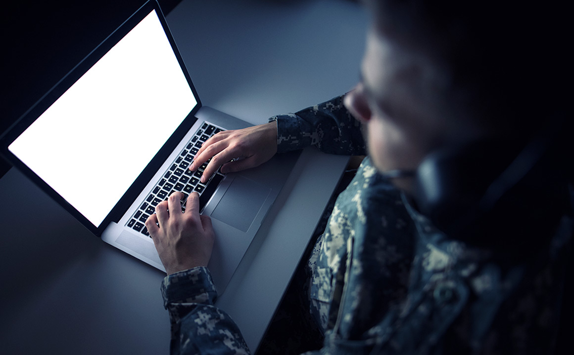 Image of a military solider using a laptop