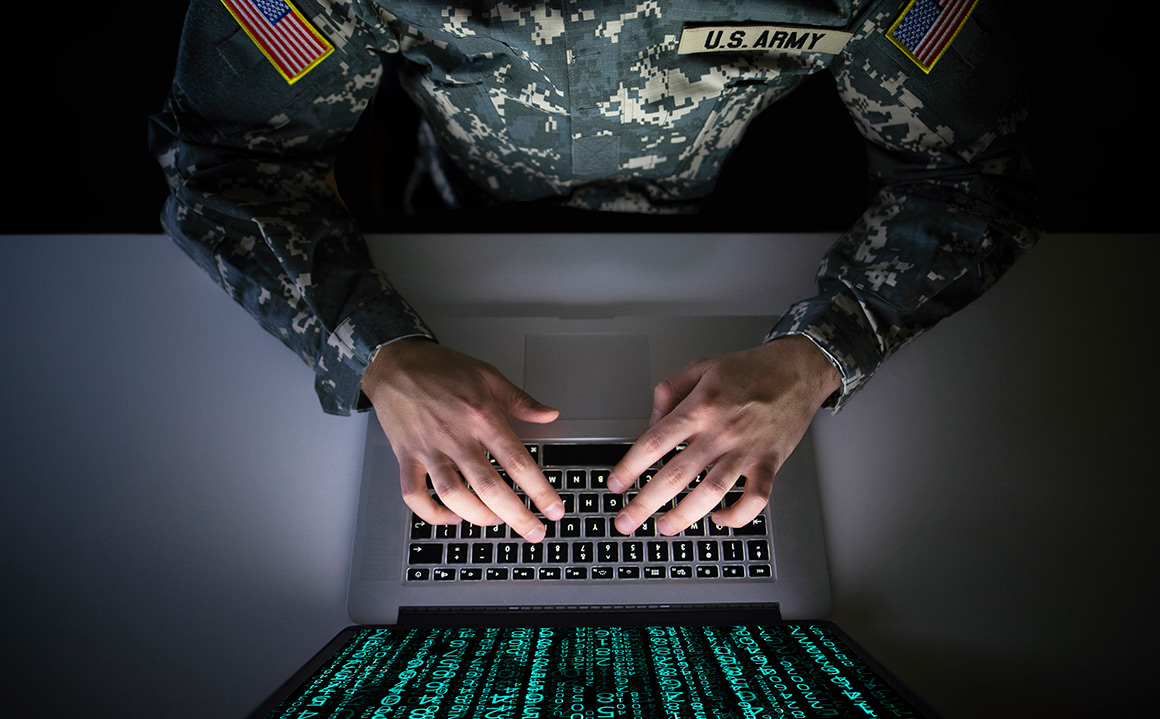 Image of American solider on a computer.