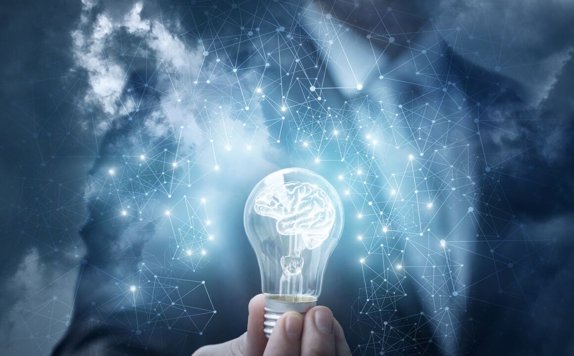 Image of a person holding a lightbulb with a brain inside
