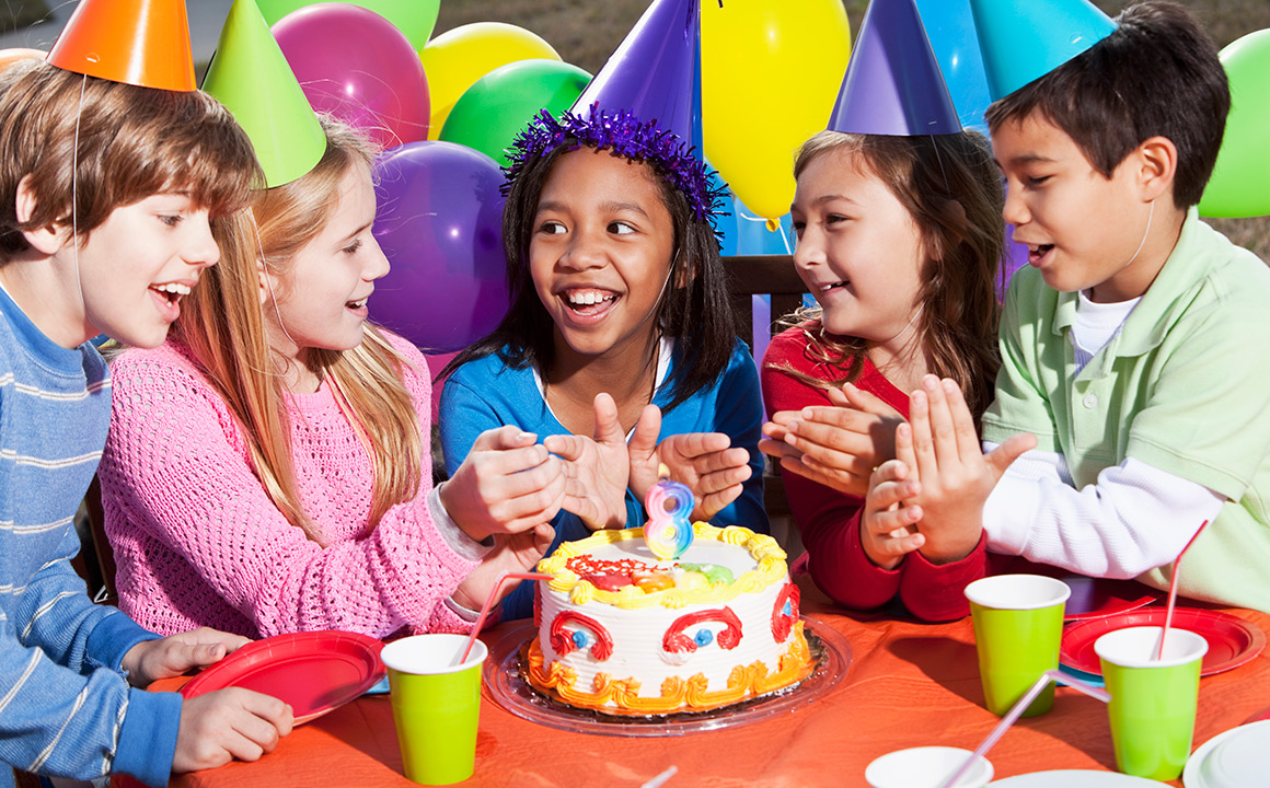Image of children smiling at a birthday party