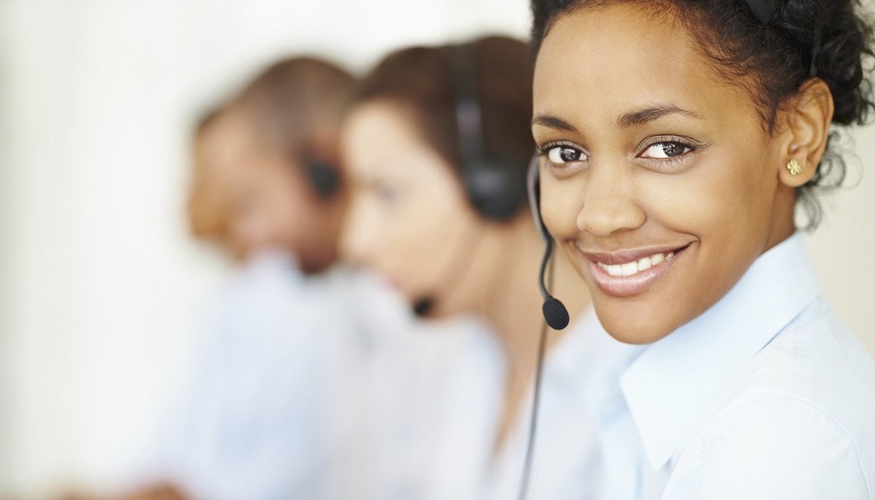 Image of people working in a contact center smiling