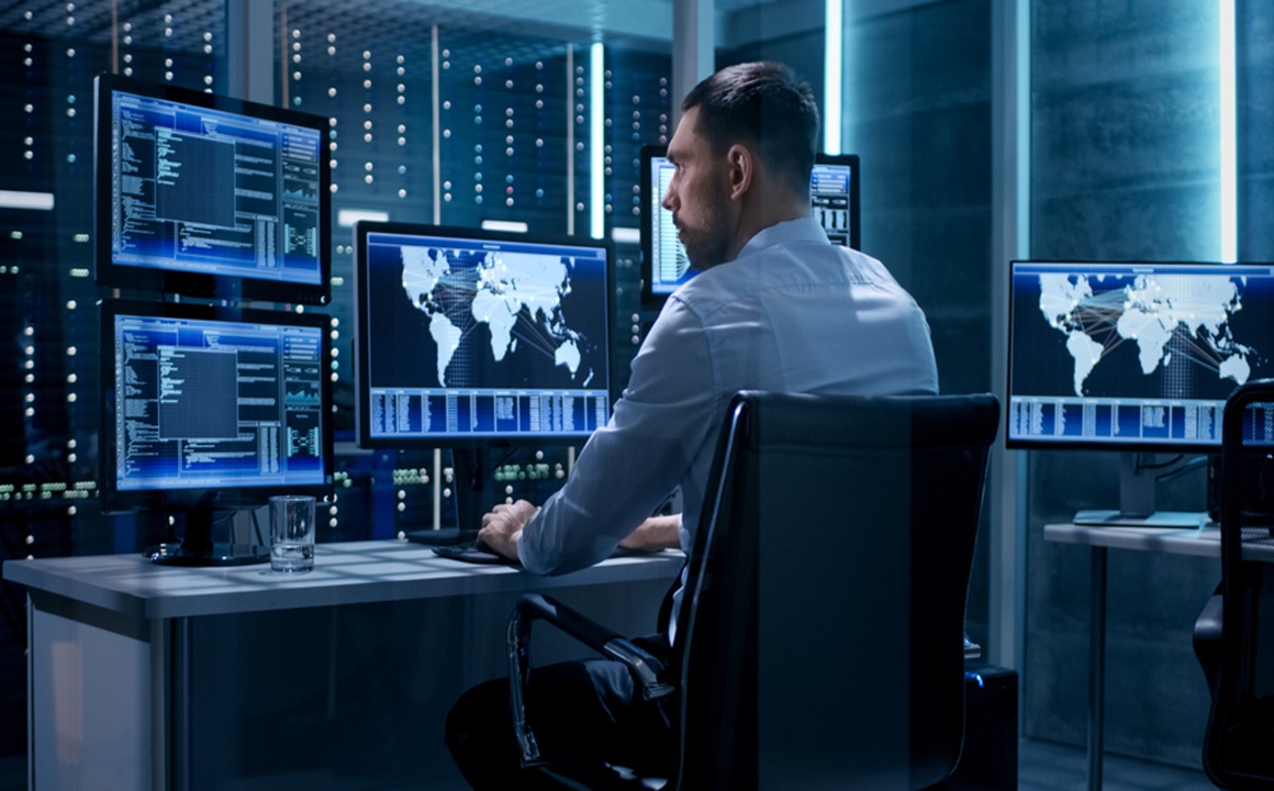 Image of a analyst using multiple computers