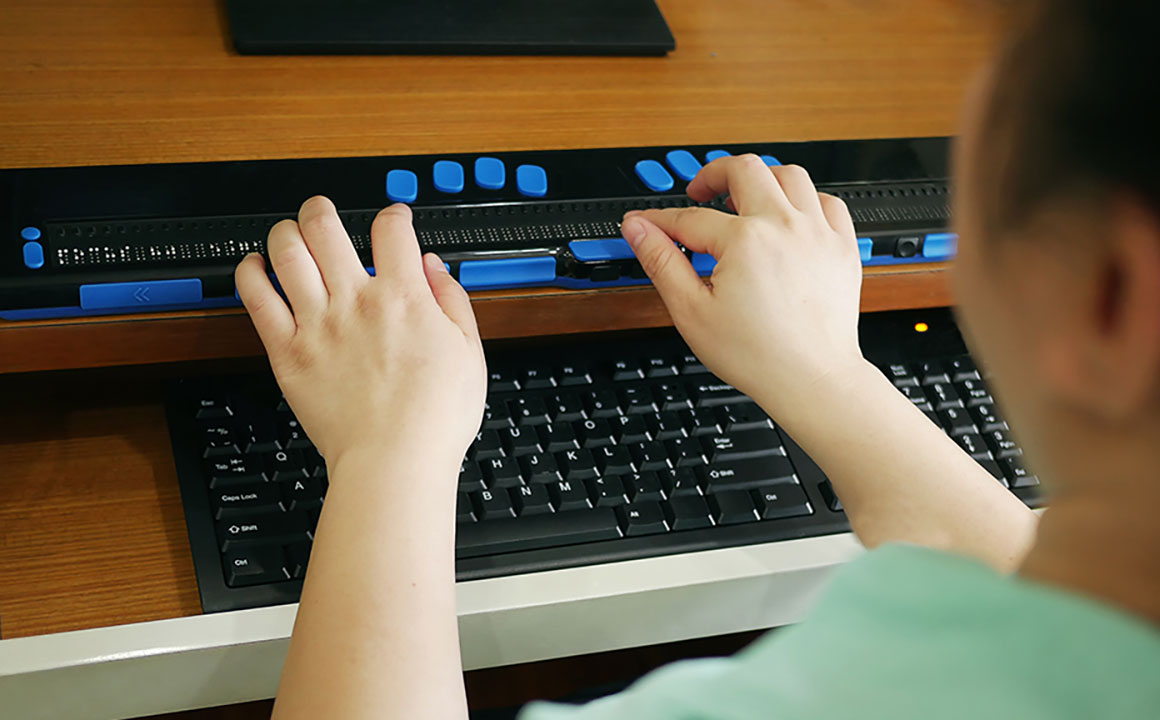 Woman typing on an accessibility keyboard