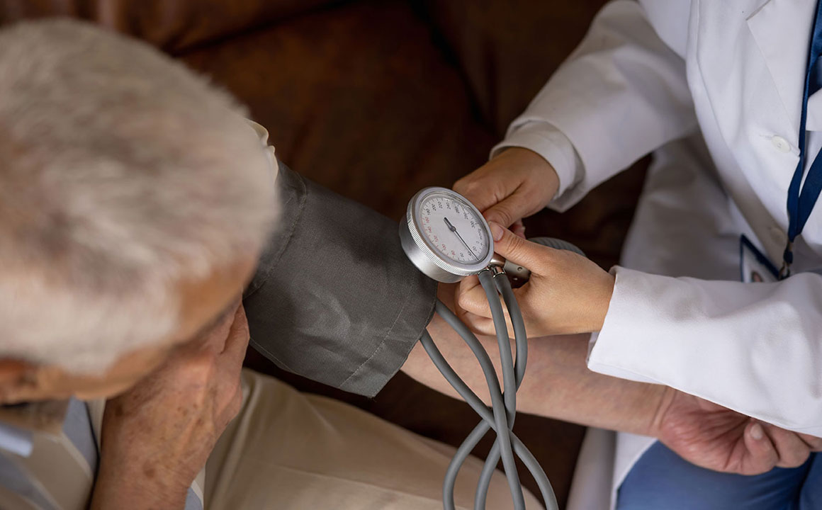 Image of a doctor taking a patients blood pressure
