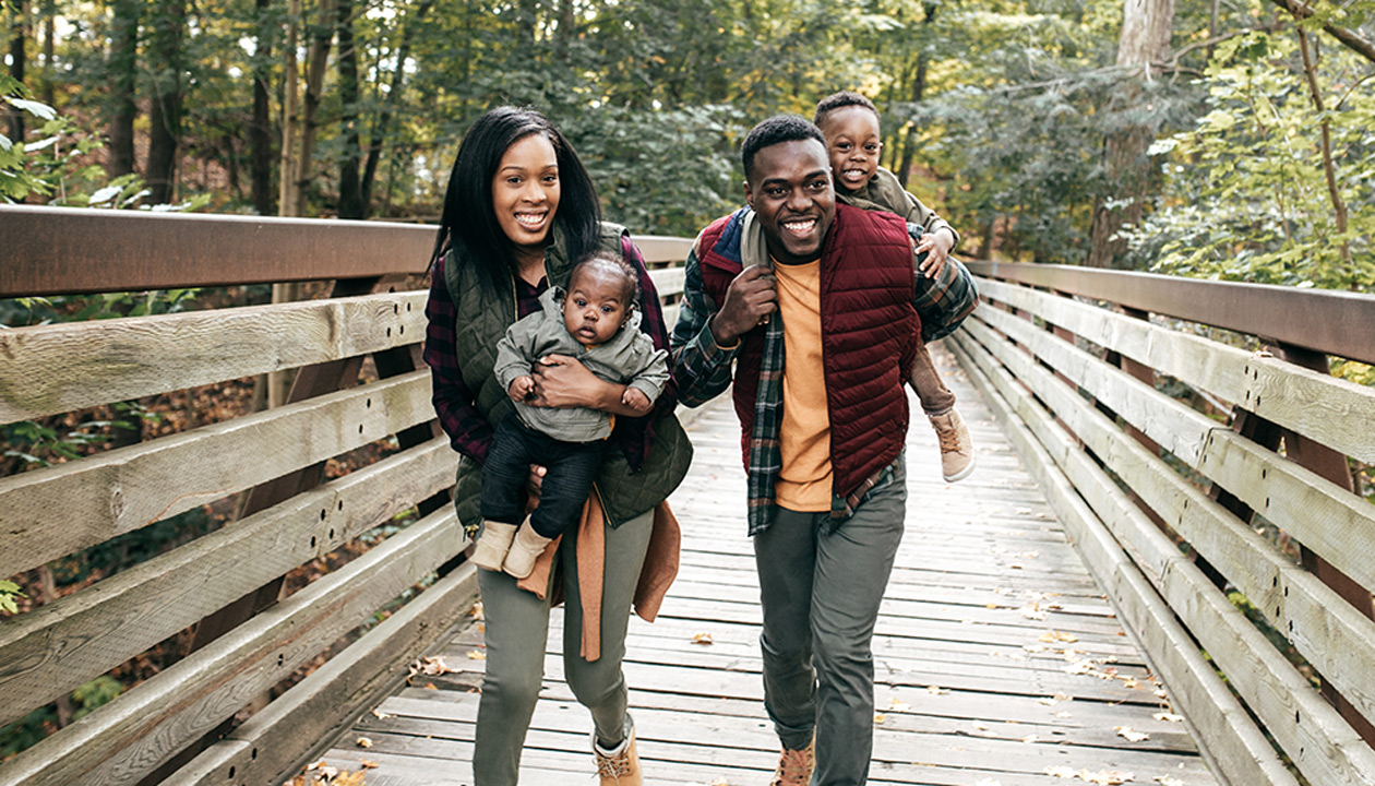 Image of a family walking over a bridge