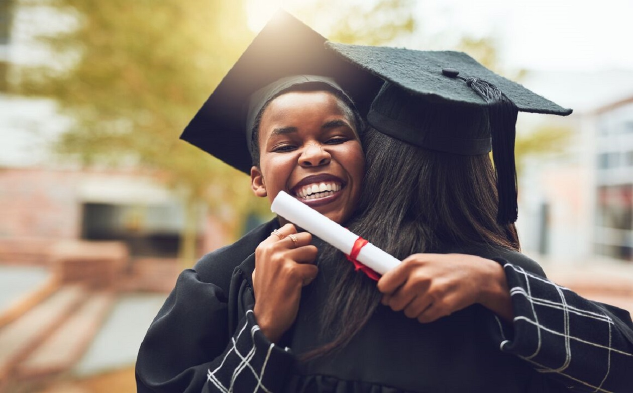Image of two people hugging right after graduation