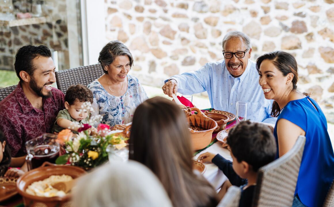 Image of a family siting a table eating a meal