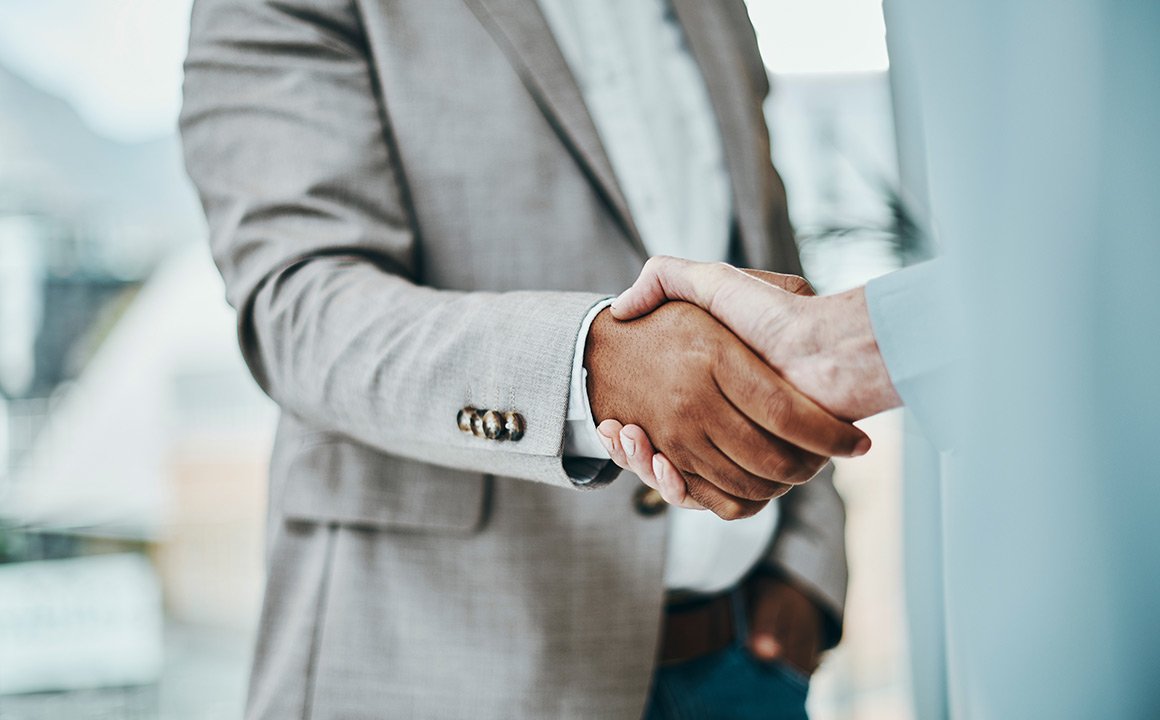 Image of two business professionals shaking hands