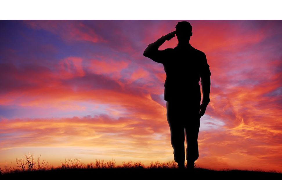 Image of a solider saluting at sunset