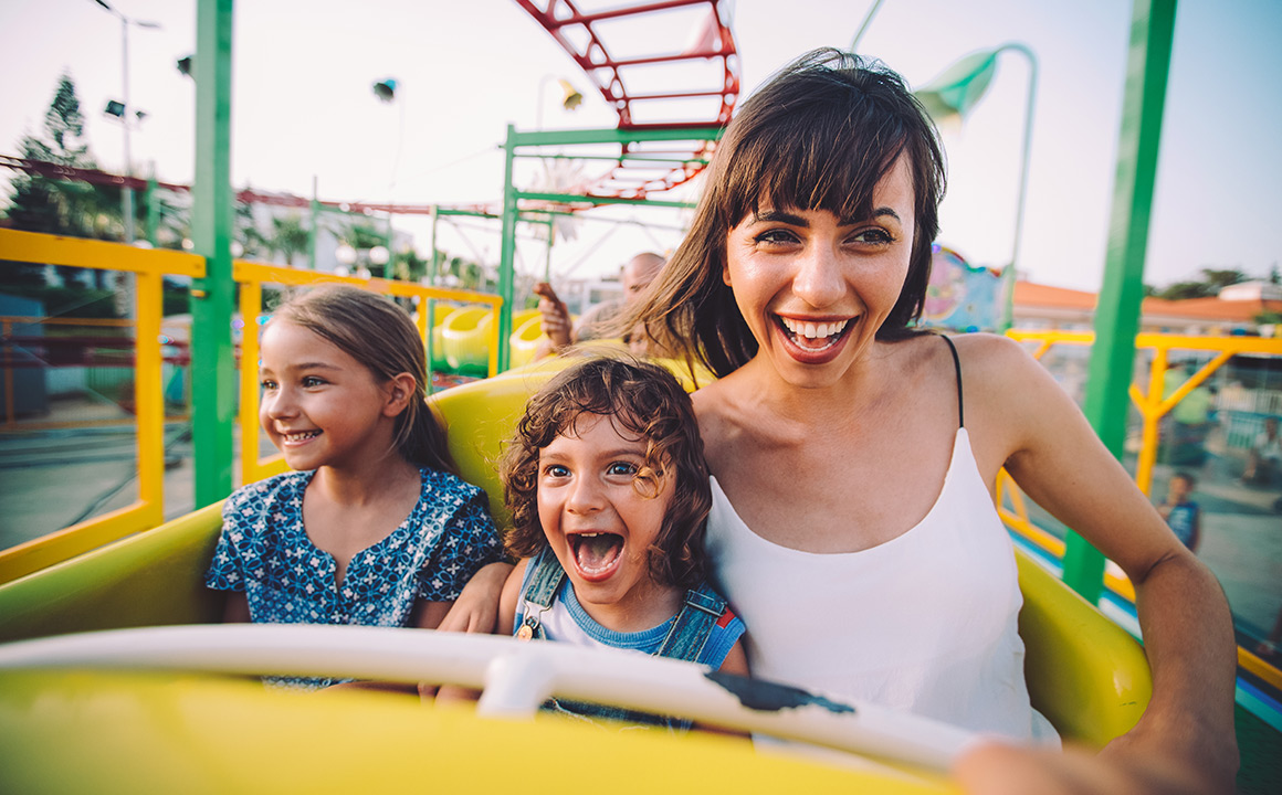 Image of a mother, daughter and son on a roller coaster