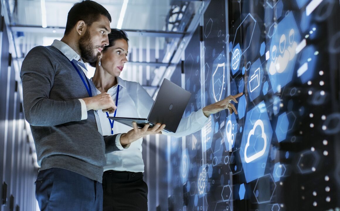 Image of a woman and a man standing in a data center