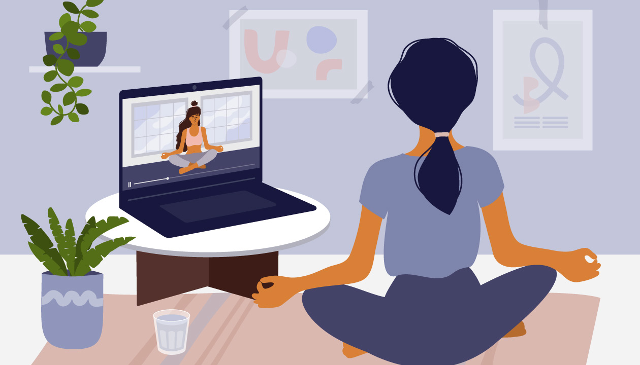 Image of woman mediating in front of laptop. 