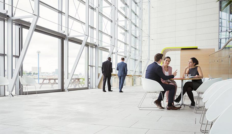 Image of business colleagues meeting in an open concept work environment. 