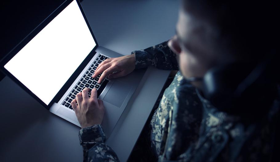 Image of an American solider on a laptop