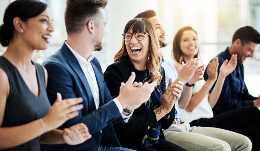 Image of business professionals smiling and clapping