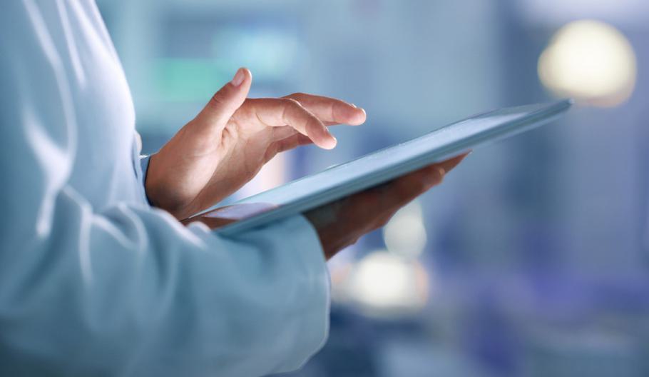 Image of a healthcare professional holding a tablet
