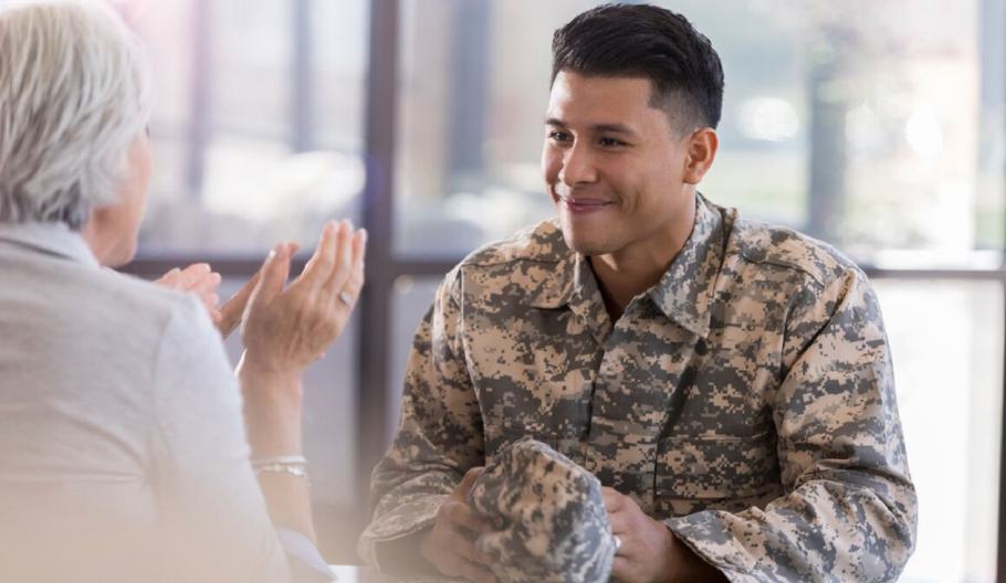 Image of a Veteran smiling while talking to an employer