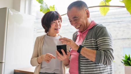 Image of man and woman looking a mobile device