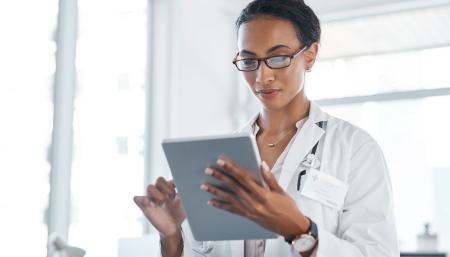 Image of a doctor looking at her tablet